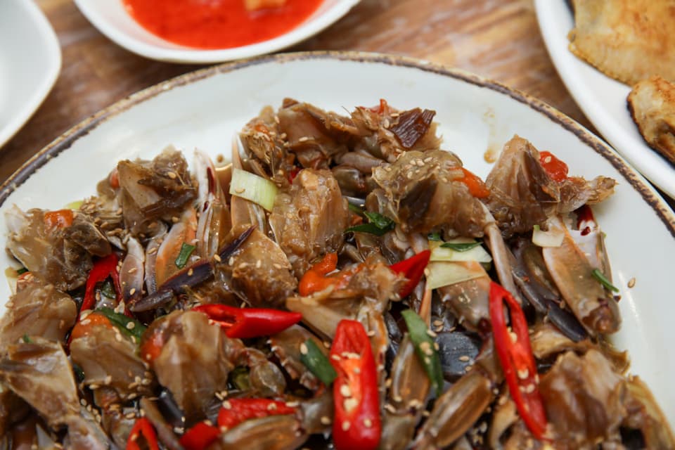 Side-by-side comparison of soy marinated crab and spicy marinated crab