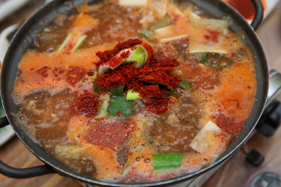 Bubbling pot of seodeori-tang, red fish bone stew with tofu and vegetables