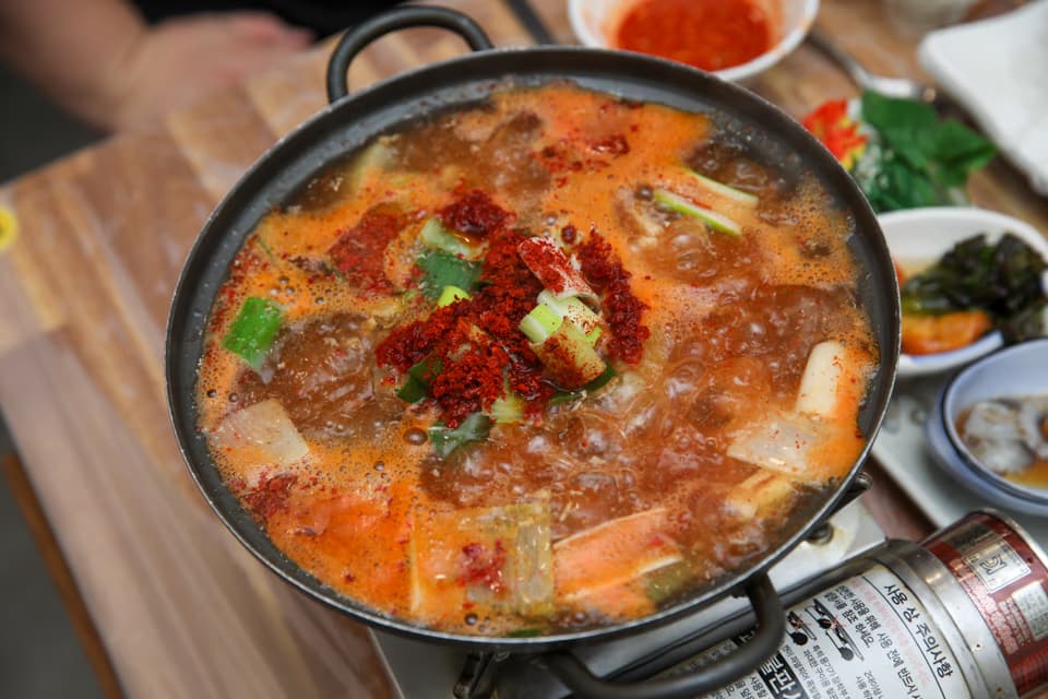 Banga leaf from Busan-style stew next to water parsley from Seoul-style stew